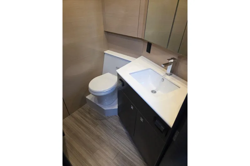 Slide: The Image of 2018 Cruisers Yachts 54 Cantius bathroom with modern sink and toilet. - 28