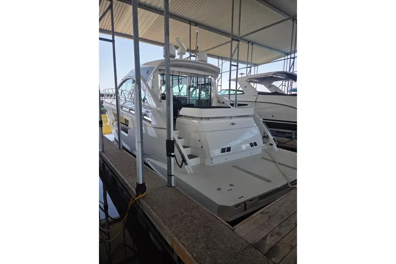 Slide: The Image of 2018 Cruisers Yachts 54 Cantius docked in a covered marina. - 5