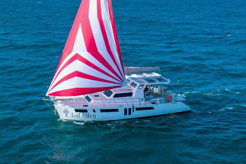 Slide: The Image of 2021 Royal Cape Catamarans Majestic sailing with red and white sail on open sea. - 12