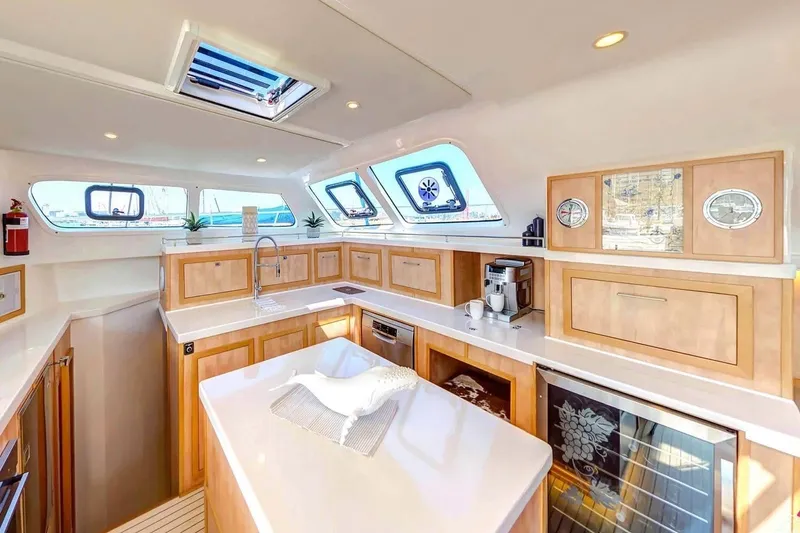 Slide: The Image of Luxurious 2021 Royal Cape Catamarans Majestic kitchen with modern amenities and elegant wood cabinetry. - 14