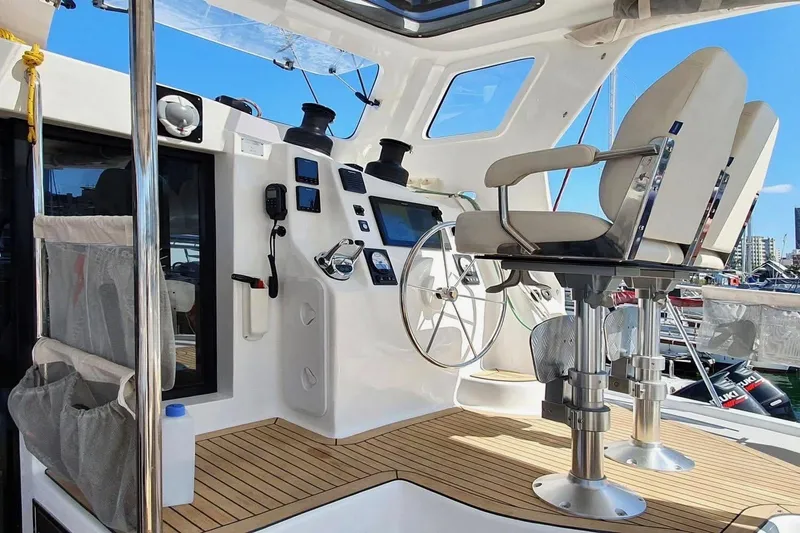 Slide: The Image of Cockpit of 2021 Royal Cape Catamarans Majestic with modern controls and seating. - 16