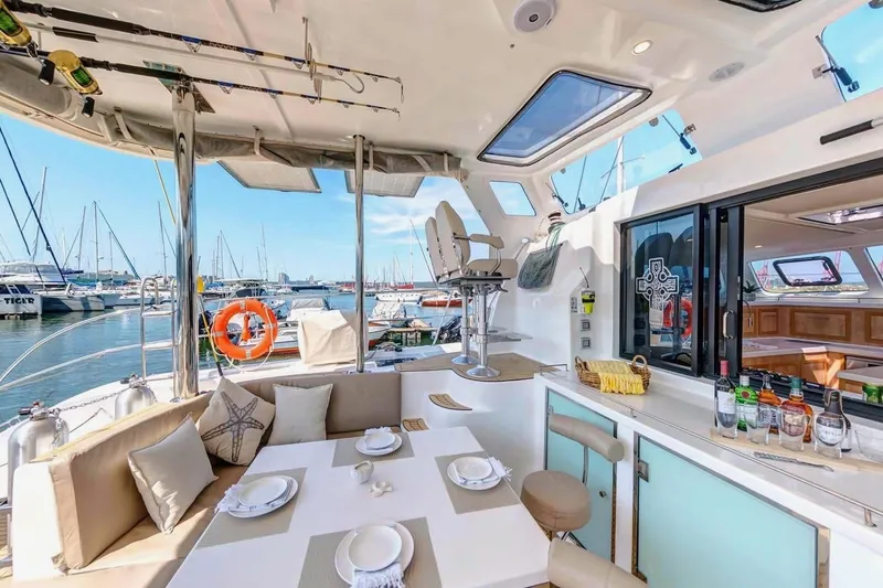 Slide: The Image of Luxurious 2021 Royal Cape Catamarans Majestic yacht interior with dining area and marina view. - 20