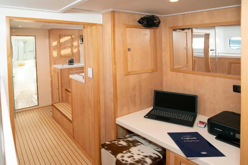 Slide: The Image of Interior of 2021 Royal Cape Catamarans Majestic with workspace, laptop, and printer. - 22