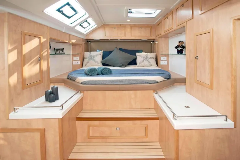 Slide: The Image of Luxurious 2021 Royal Cape Catamarans Majestic cabin interior with cozy bed and elegant wood finish. - 26