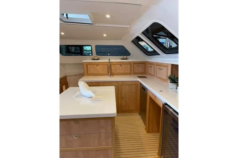 Slide: The Image of Luxurious 2021 Royal Cape Catamarans Majestic kitchen with modern wood cabinetry and sleek countertops. - 31