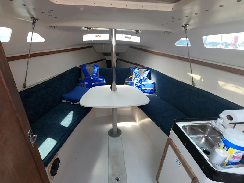 Slide: The Image of Interior of a 1998 Catalina 250 yacht with seating and kitchenette. - 4