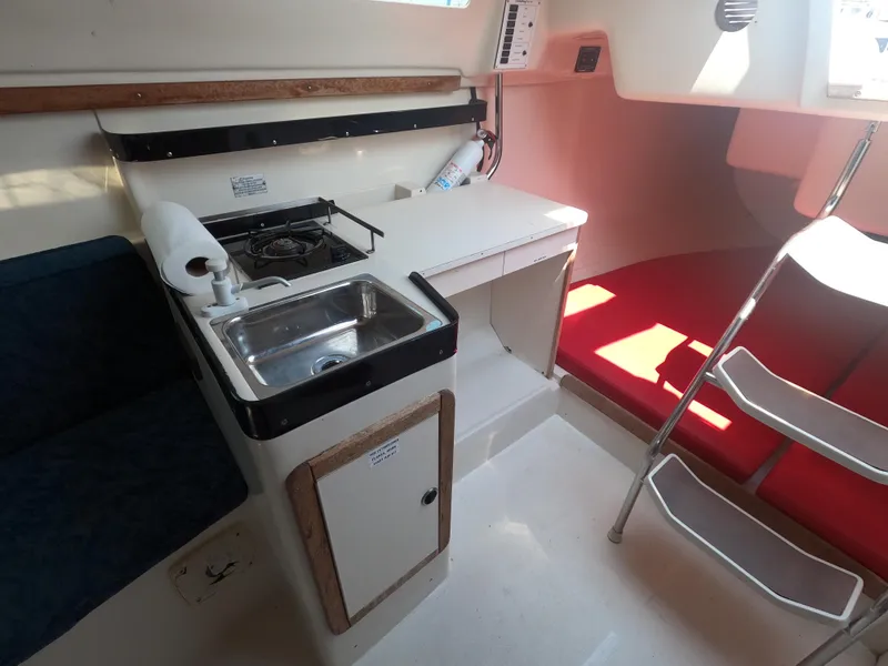 Slide: The Image of Interior of a 1998 Catalina 250 with kitchenette and seating area. - 8