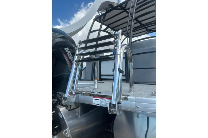 Slide: The Image of 2026 Godfrey Monaco Sun Deck 235 SDC helm with luxurious captain's chair and modern controls. - 13