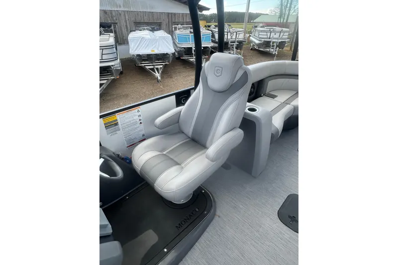 Slide: The Image of Luxurious seating on 2026 Godfrey Monaco Sun Deck 235 SDC with cup holder and speaker. - 16