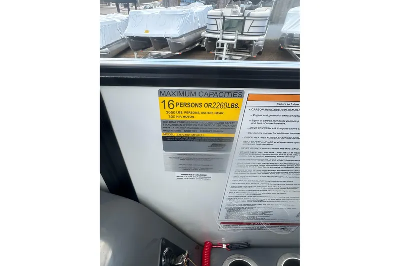 Slide: The Image of 2026 Godfrey Monaco Sun Deck 235 SDC boat interior with gray seating. - 23