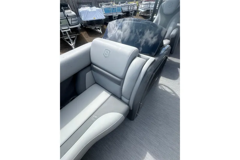 Slide: The Image of 2026 Godfrey Monaco Sun Deck 235 SDC boat with open storage compartment and gray seating. - 36