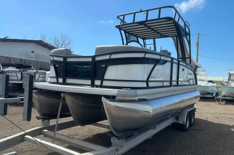 Slide: The Image of 2026 Godfrey Monaco Sun Deck 235 SDC pontoon boat on trailer, outdoor setting. - 4