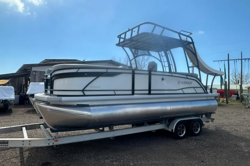 Slide: The Image of 2026 Godfrey Monaco Sun Deck 235 SDC pontoon boat with slide on trailer. - 5