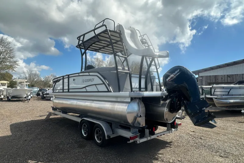 Slide: The Image of 2026 Godfrey Monaco Sun Deck 235 SDC boat with slide, parked outdoors. - 7
