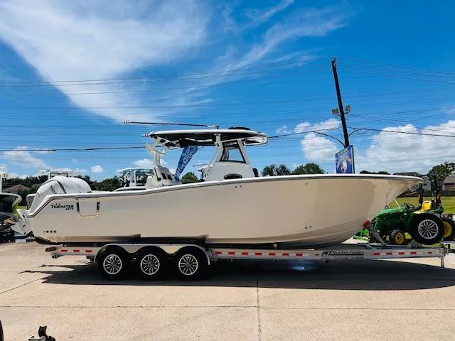 The Image of Tidewater 302 CC Adventure 2026 boat on trailer under clear blue sky. - 0