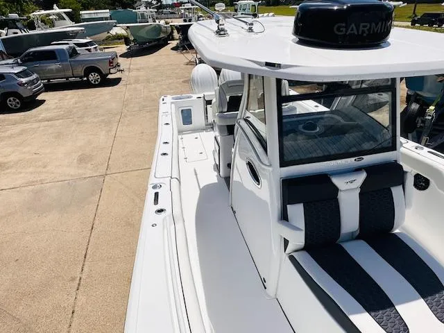 Slide: The Image of 2026 Tidewater 302 CC Adventure boat with Garmin equipment, parked in a marina. - 10