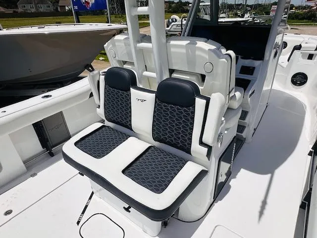 Slide: The Image of 2026 Tidewater 302 CC Adventure boat interior with cushioned seating and modern design. - 3