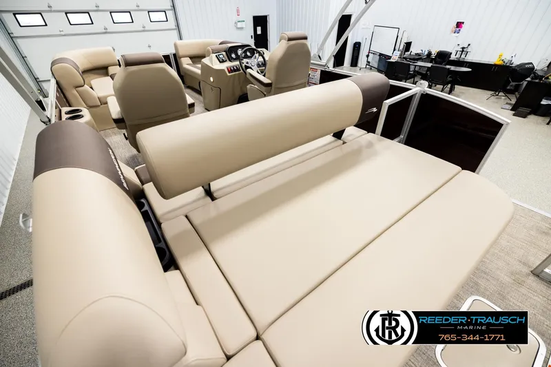 Slide: The Image of 2026 Bennington SSBSF boat interior with beige seating, showcased at Reeder-Trausch Marine. - 11