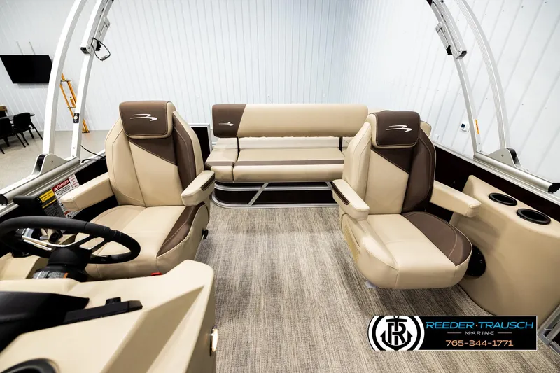Slide: The Image of 2026 Bennington SSBSF boat interior with beige and brown seating, steering wheel, and cup holders. - 14