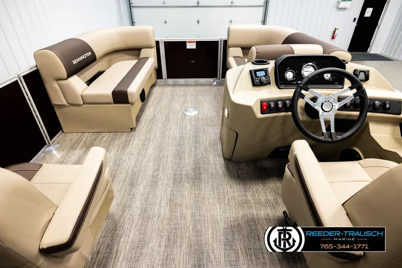 Slide: The Image of Interior of 2026 Bennington SSBSF pontoon boat with beige seating and modern dashboard. - 17