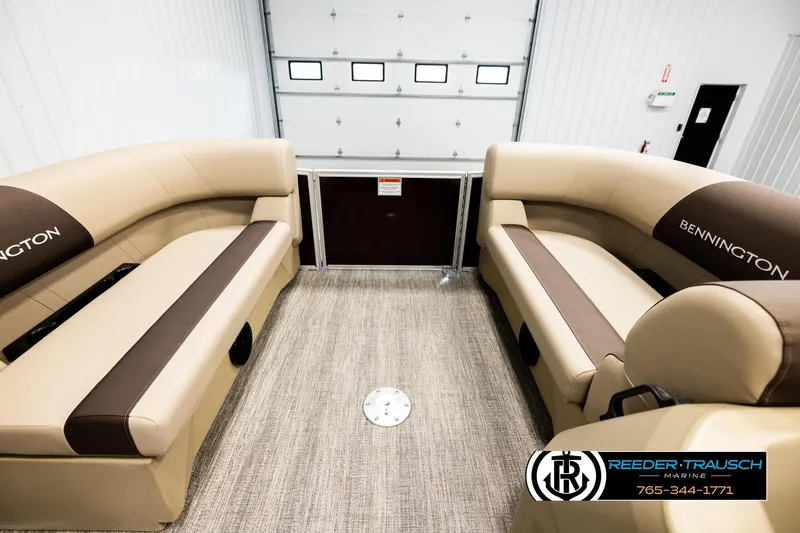 Slide: The Image of Interior of 2026 Bennington SSBSF pontoon boat with beige seating and logo. - 18
