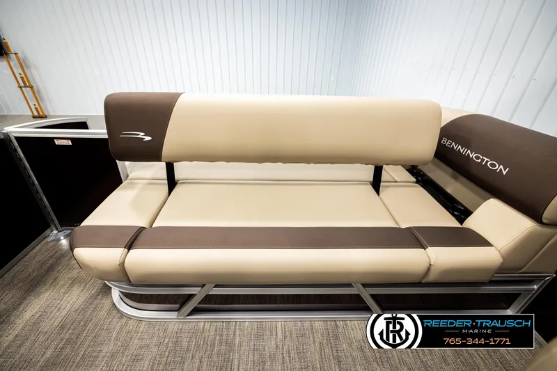 Slide: The Image of 2026 Bennington SSBSF boat seating with beige and brown upholstery in showroom. - 22