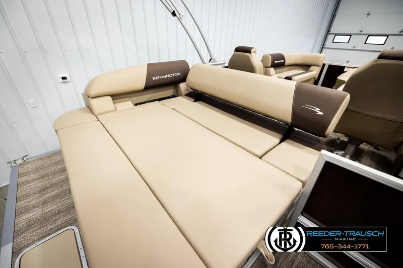 Slide: The Image of 2026 Bennington SSBSF boat interior with beige seating and logo, showcased at Reeder-Trausch Marine. - 24