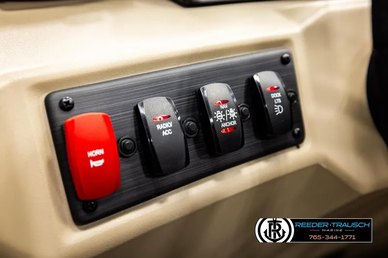 Slide: The Image of Control panel of 2026 Bennington SSBSF boat with switches for horn, radio, and lights. - 29