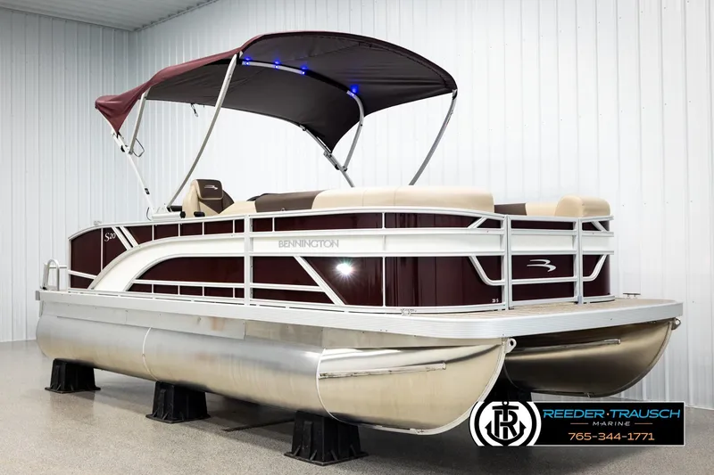 Slide: The Image of 2026 Bennington SSBSF pontoon boat with canopy in showroom display. - 3
