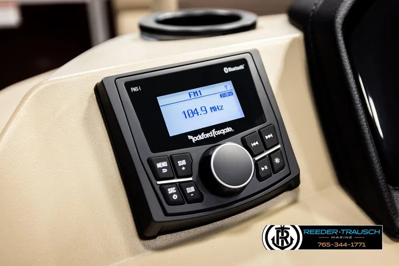 Slide: The Image of 2026 Bennington SSBSF boat stereo system displaying FM 104.9 MHz with Bluetooth connectivity. - 30
