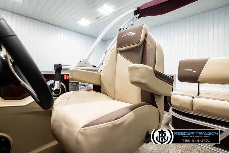 Slide: The Image of 2026 Bennington SSBSF boat interior with beige and brown seating, steering wheel, and controls. - 37