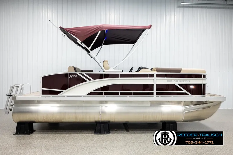 Slide: The Image of 2026 Bennington SSBSF pontoon boat with maroon canopy and sleek design in showroom. - 5
