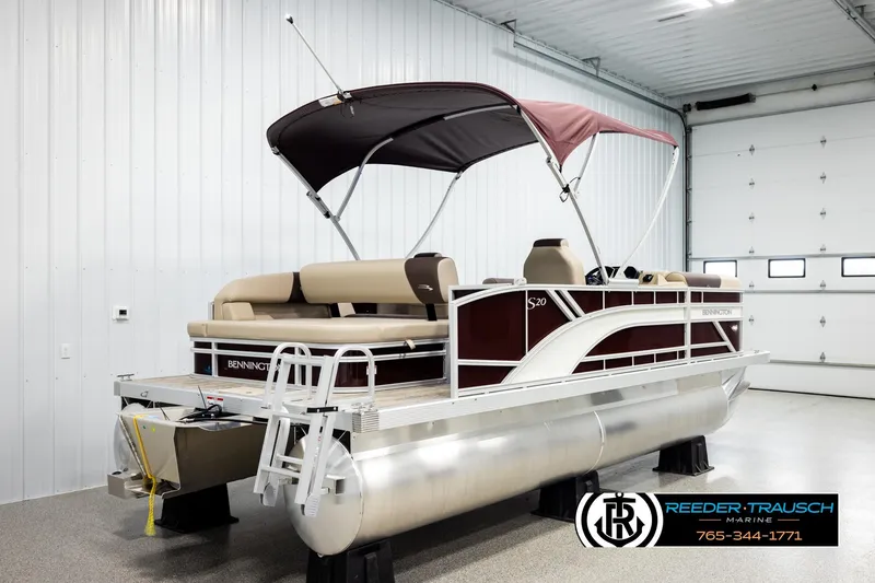 Slide: The Image of 2026 Bennington SSBSF pontoon boat in showroom with canopy and seating. - 6