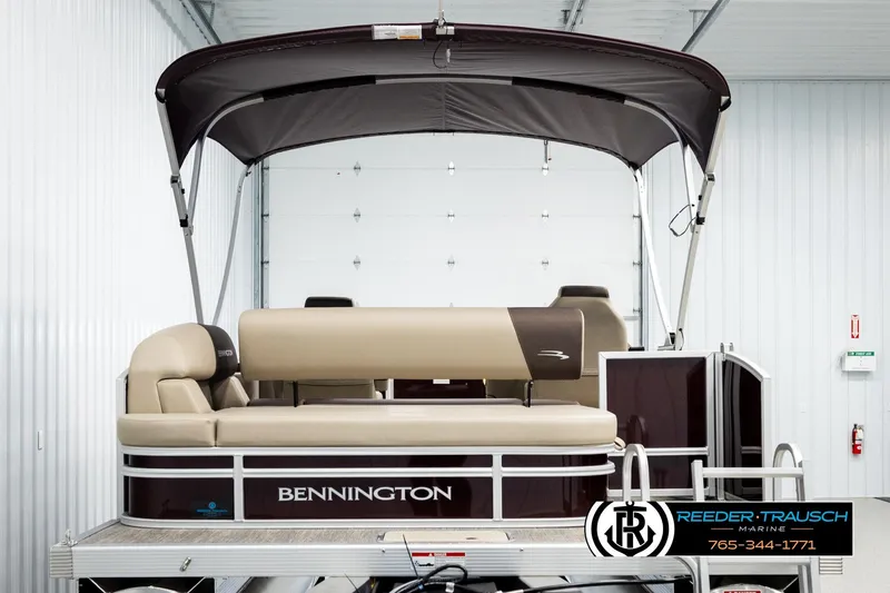 Slide: The Image of 2026 Bennington SSBSF pontoon boat in showroom with canopy and seating. - 7