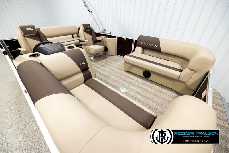 Slide: The Image of 2026 Bennington SSBSF boat interior with beige and brown seating, Reeder-Trausch Marine logo. - 9