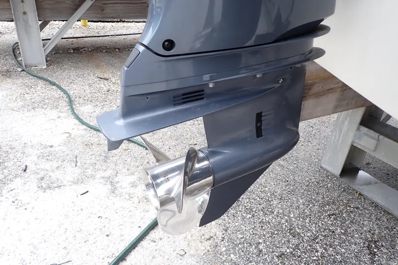 Slide: The Image of 2016 Grady-White Freedom 275 boat motor and propeller on gravel surface. - 104