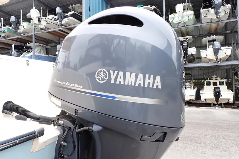 Slide: The Image of Yamaha four-stroke engine on 2016 Grady-White Freedom 275, with boats in storage background. - 105
