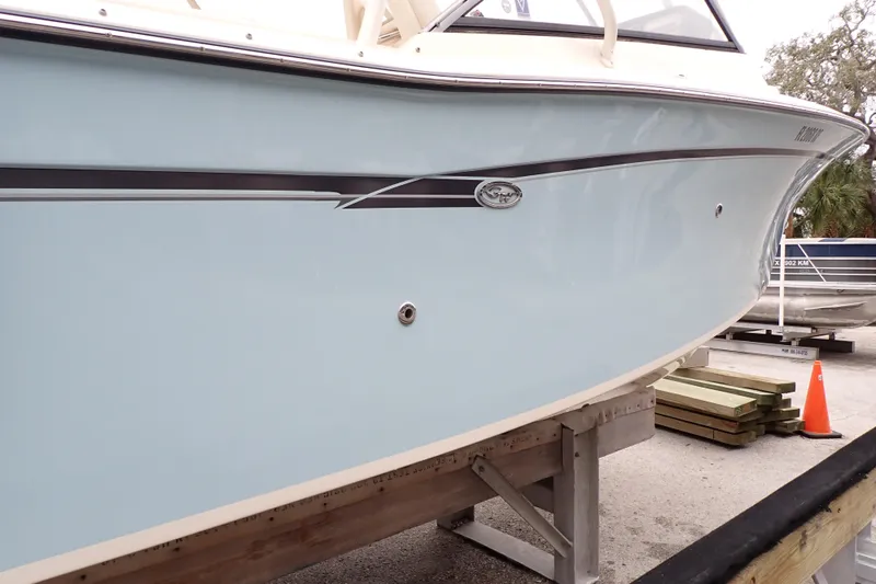Slide: The Image of 2016 Grady-White Freedom 275 boat on display, light blue hull, sleek design. - 111