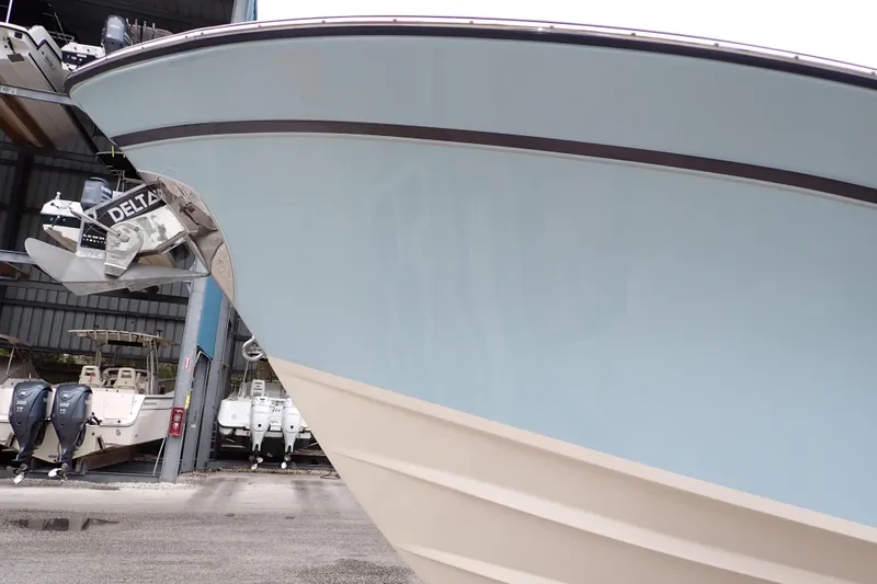 Slide: The Image of 2016 Grady-White Freedom 275 boat in storage, showcasing sleek hull design. - 114