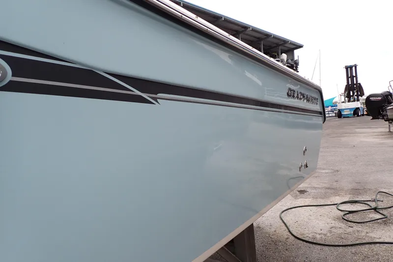 Slide: The Image of 2016 Grady-White Freedom 275 boat side view at a marina. - 117