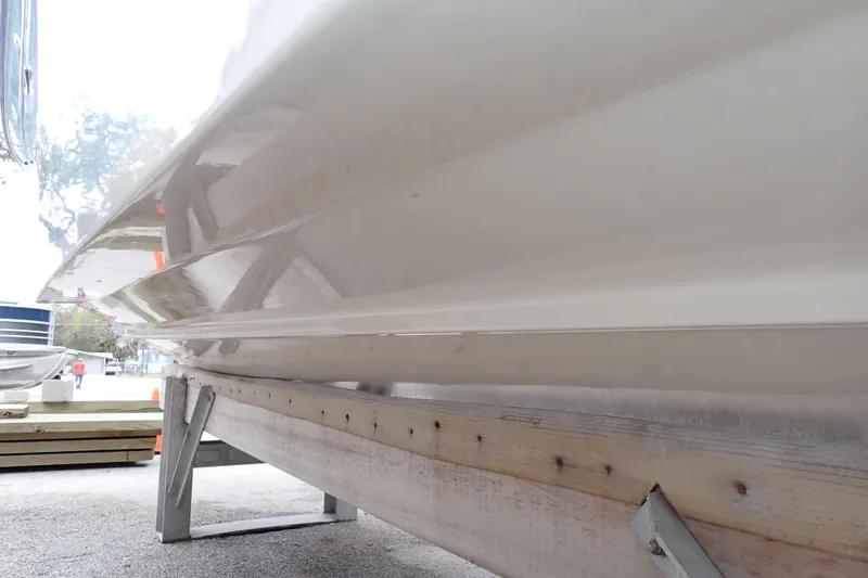Slide: The Image of 2016 Grady-White Freedom 275 boat hull on a trailer, side view. - 120