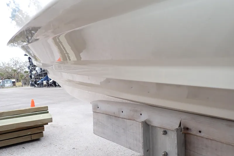 Slide: The Image of 2016 Grady-White Freedom 275 boat hull on trailer, side view. - 122