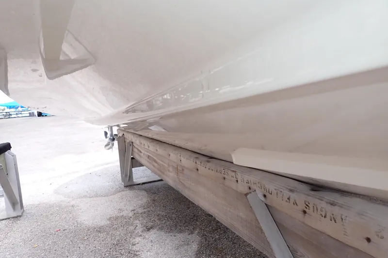 Slide: The Image of 2016 Grady-White Freedom 275 boat hull on a trailer, close-up view. - 128