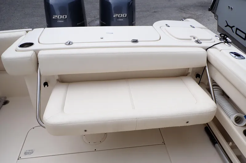 Slide: The Image of 2016 Grady-White Freedom 275 boat interior with Yamaha 200 engines, featuring a foldable seat. - 19
