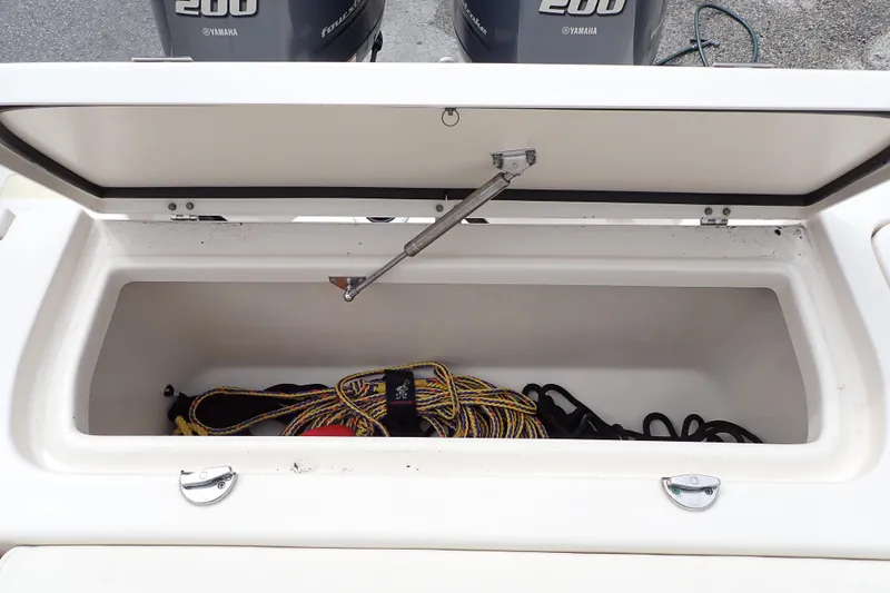 Slide: The Image of Open storage compartment on 2016 Grady-White Freedom 275 boat with ropes inside. - 21