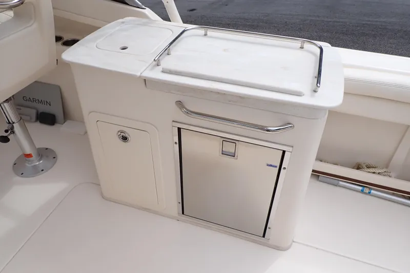 Slide: The Image of 2016 Grady-White Freedom 275 boat interior with storage and Garmin equipment. - 24