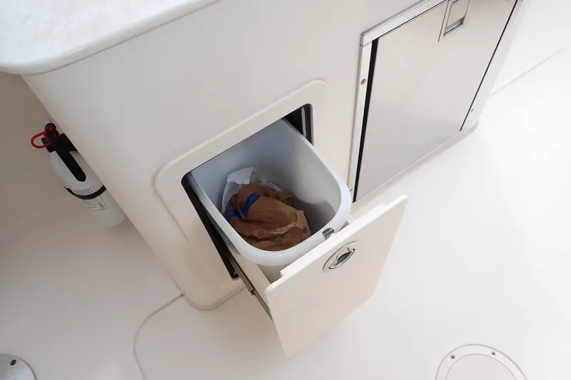Slide: The Image of Built-in trash compartment on 2016 Grady-White Freedom 275 boat. - 29