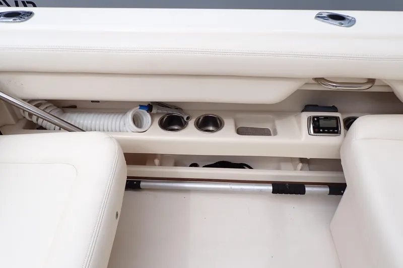 Slide: The Image of 2016 Grady-White Freedom 275 boat interior with cup holders and storage compartments. - 30