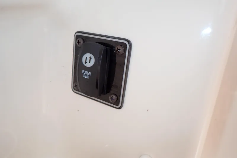 Slide: The Image of Power seat control switch on 2016 Grady-White Freedom 275 boat interior. - 38