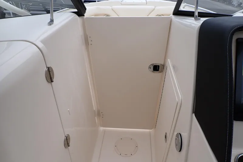 Slide: The Image of 2016 Grady-White Freedom 275 boat interior, featuring a sleek, modern design with storage compartments. - 51